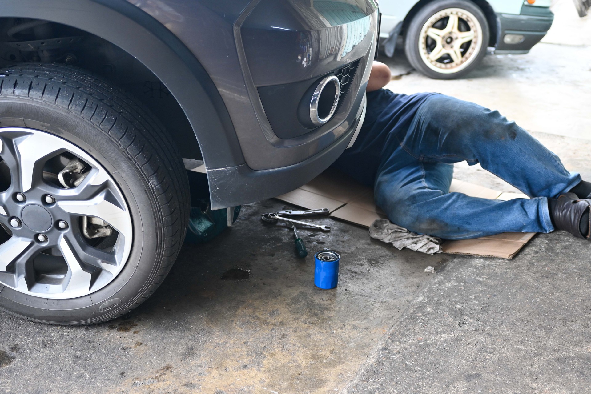 Auto mechanic working under car