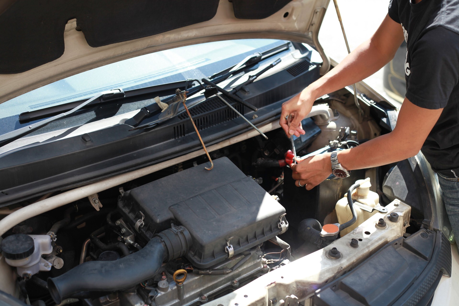 High Angle View Of Man Working On Car