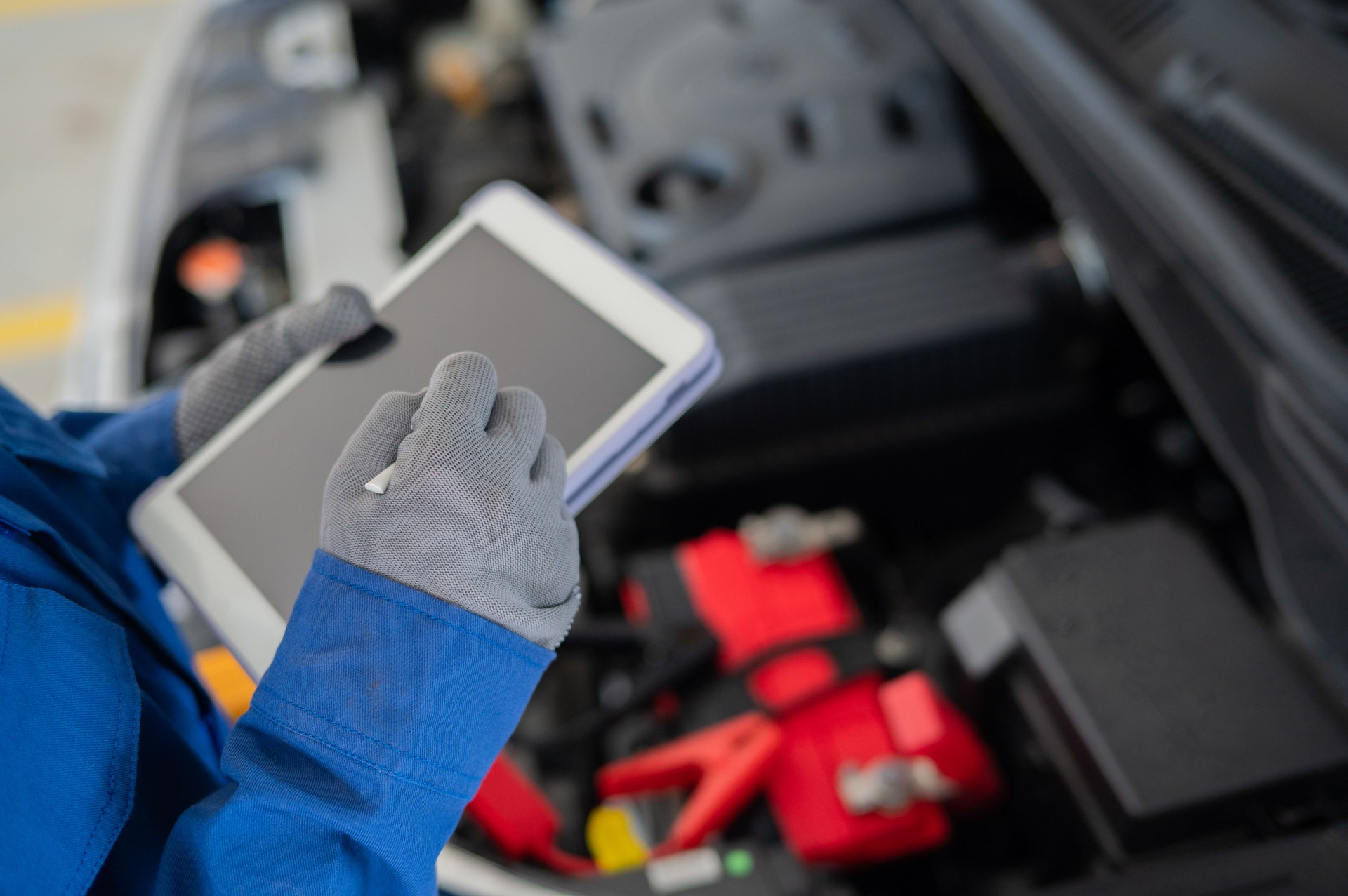 Mechanic using smart tablet check and record vehicle status condition stock photo