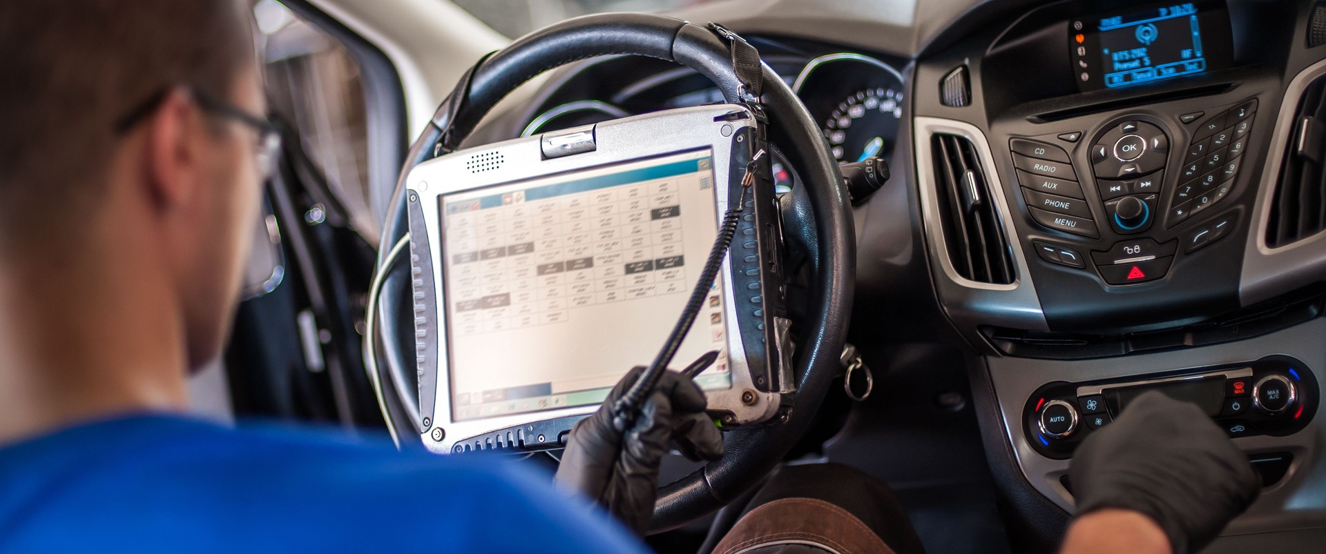 Automobile computer diagnosis. Car mechanic repairer looks for engine failure